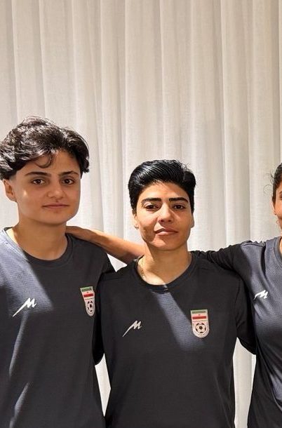 In this photo supplied by Australia's Minister for Home Affairs Tony Burke's office, the Minister Tony Burke, center, poses in an undisclosed location with five Iranian women soccer players who have been granted asylum in Australia, Tuesday, March 10, 2026. (Australia Ministry of Home Affairs via AP)