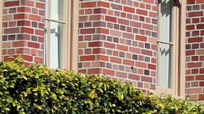 FILE - In this Tuesday, March 12, 2019 file photo, people pose for photos in front of the iconic Tommy Trojan statue on the campus of the University of Southern California in Los Angeles. The university says a review of students possibly connected to a college admissions bribery scandal could lead to expulsions. The university said in a statement Monday, March 18, 2019, it has placed holds on the accounts of those students, which prevents them from registering for classes or acquiring transcripts while their cases are under review. (AP Photo/Reed Saxon,File)