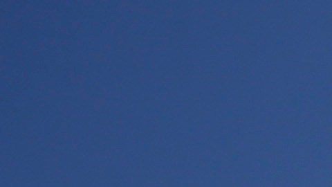 In this photo taken with a fisheye lens, Merissa Rocha, left, of Anaheim Calif., and Celso Arreola, of Los Angeles, plant their beach umbrella on the sand in an effort to avoid the ongoing southern California heat wave, Monday, Sept. 15, 2014, in Huntington Beach, Calif. Southern California is roasting in triple-digit temperatures and forecasters say the heat wave will continue at least another day. (AP Photo/Chris Carlson)