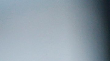 A handcuffed suspect waits inside a police bus during an operation against alleged drug traffickers at the Complexo do Alemao slum in Rio de Janeiro, Brazil, Saturday, Nov. 27, 2010. Soldiers and police crouching behind armored vehicles trained their rifles on dozens of entrances to a sprawling slum Saturday, preparing to invade and try to push drug gangs out an area long considered the most dangerous in Rio de Janeiro, a city set to host the 2016 Olympics. (AP Photo/Felipe Dana)