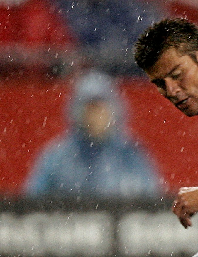 New England Revolution's Jose Cancela, bottom, goes after a loose ball with Chivas USA's Ramon Ramirez during the second half of the Revolution's 1-0 win at Gillette Stadium in Foxboro, Mass., Saturday, April 30, 2005. (AP Photo/Winslow Townson)