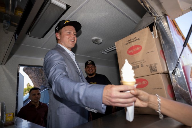 Los Angeles mayoral candidate Spencer Pratt poses with Juan Alba in his All American Softie ice cream truck during a campaign event Sunday, May 31, 2026, in Los Angeles. (AP Photo/Jill Connelly)