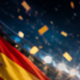 Trofeo dorado de fútbol en un estadio iluminado con banderas de distintos países alrededor