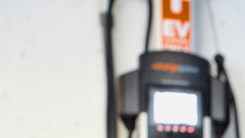 FILE - This Wednesday, Oct. 17, 2018 file photo shows a Chevrolet Volt hybrid car charging at a ChargePoint charging station at a parking garage in Los Angeles. If U.S. consumers ever ditch fuel burners for electric vehicles, then the United Auto Workers union is in trouble. Gone would be thousands of jobs at engine and transmission plants across the industrial Midwest, replaced by smaller workforces at squeaky-clean mostly automated factories that mix up chemicals to make batteries. (AP Photo/Richard Vogel, File)