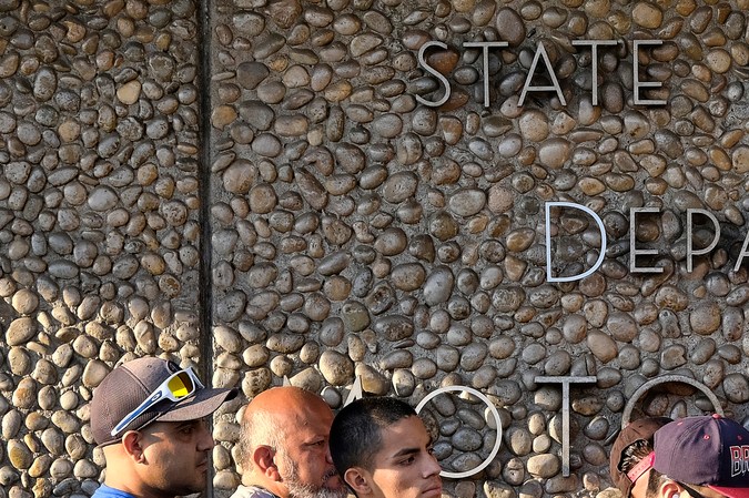 FILE - In this Aug. 7, 2018, file photo, people line up at the California Department of Motor Vehicles prior to opening in the Van Nuys section of Los Angeles. An audit issued by California Department of Finance and released on Wednesday, March 27, 2019, say the DMV didn't properly prepare for customers seeking to get new federally approved drivers' licenses, leading to hours-long wait times. (AP Photo/Richard Vogel, File)