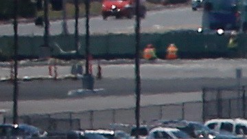In this Friday, May 13, 2016, photo, as a commercial airliner taxis for takeoff, the perimeter fencing and razor wires show the layers of security at San Diego International Airport. An Associated Press investigation has documented perimeter breaches at many of the busiest airports in the U.S. (AP Photo/Lenny Ignelzi)