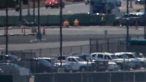 In this Friday, May 13, 2016, photo, as a commercial airliner taxis for takeoff, the perimeter fencing and razor wires show the layers of security at San Diego International Airport. An Associated Press investigation has documented perimeter breaches at many of the busiest airports in the U.S. (AP Photo/Lenny Ignelzi)