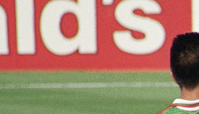 Bulgaria?s Emil Kostadinov, left, falls as Mexican opponent Jorge Rodriguez watches during their second round world Cup soccer match at Giants Stadium, East Rutherford, N.J., Tuesday, July 5, 1994. The winner of this match will play Germany in the quarterfinals of the World Cup at Giants Stadium, Sunday, July 10. (AP Photo/Bill Kostroun)